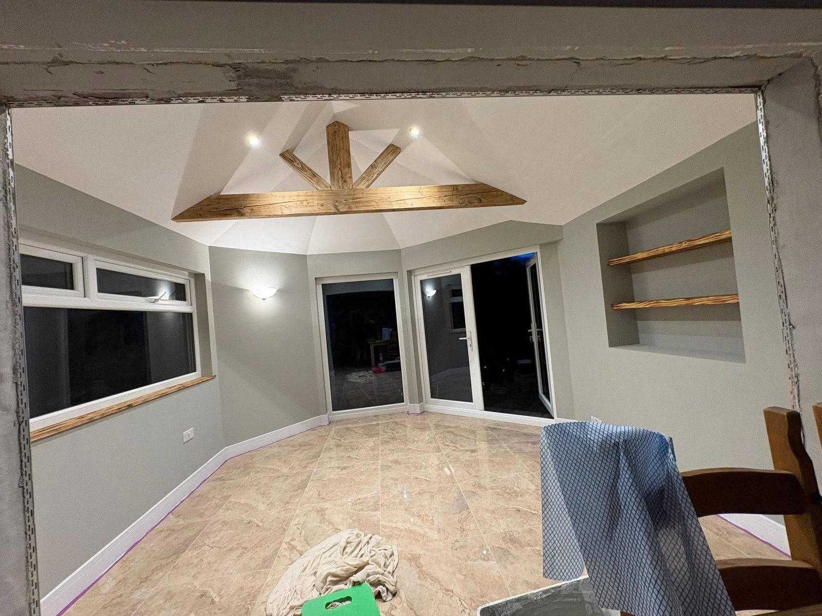 Conservatory conversion with oak king-post truss and travertine tiling, Langland Swansea